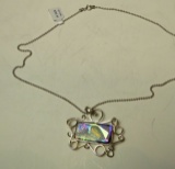 Sterling dichroic pendant framed in sterling on 20