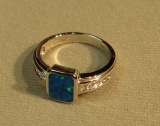 Rhodium pla. Lab created opal ring size 6 with 10 c.z. weight 4.2 g