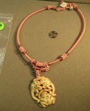 Pink silk corded necklace with pendant of 3 frogs carved from bone