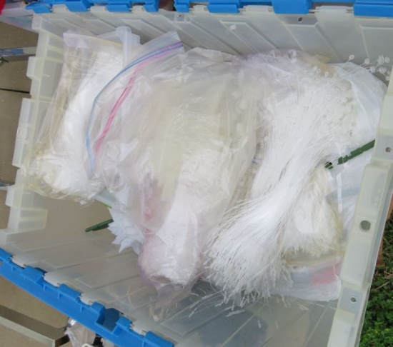 box of price tag supplies and size tapes for clothing