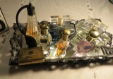 atomizer and five opened bottles of perfume with perfume tray