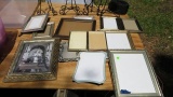 group of mixed photo frames and stands in tote