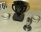 Black-eyed vase, two cups, and meat tenderizer