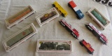 train set  with 3 toy train engines and 7 box cars