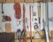 Mixed pegboard tools: C clamp, bar clamp, brushes, rake, shelving brackets, tape measures, marking s