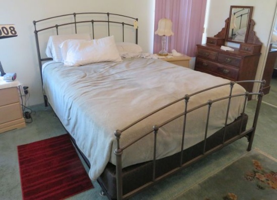 full size bed with meal headboard and foot board