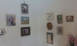 Mixed small wall décor including clock, framed needle point pictures