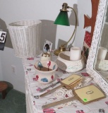 Group of dresser items - vintage hairbrush, mirror, wicker candle holder, bucket with florals, small