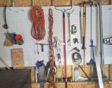 Mixed pegboard tools: C clamp, bar clamp, brushes, rake, shelving brackets, tape measures, marking s