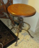 antique piano stool with cast metal legs and oak seat