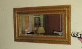 ornately framed beveled glass mirror 53