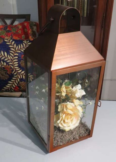 metal lantern with floral arrangement