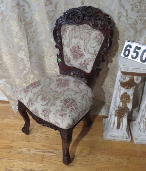 Victorian style ornately carved mahogany parlor chair]