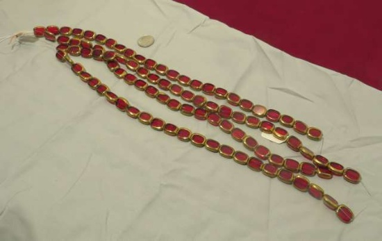 12" strands of 24 red glass beads in gold tone bezels