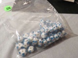 package of 41 round blue dotted white glass beads