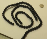strands of  smooth black round beads