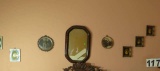 mixed mini pictures and mirror in master bedroom