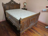 antique full size bed with carved headboard and footboard
