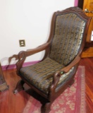 Walnut finished upholstered rocker with swan head arms