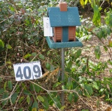 plastic bird house on pipe