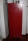 3 shelf wooden red cabinet  16 inch wide and 47 inch tall 