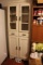 White wooden cabinet, 5 shelves, 2 drawers, top half has glass doors 26 inches wide and 69 inches ta