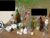 collection of old soda bottles and assorted  glassware