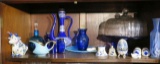16 pieces of blue glass and cake p late on top shelf of China cabinet