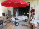 party or vending cart on large pneumatic tires with umbrella, chair and plastic table  features plac