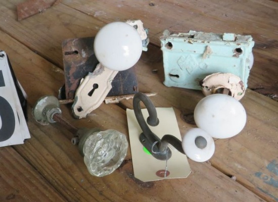 glass and p porcelain door knobs and one cast metal coat hanger