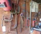 assorted C clamps and tools on upper wall of storage trailer