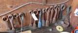 assorted heavy duty end wrenches on lower wall of storage trailer