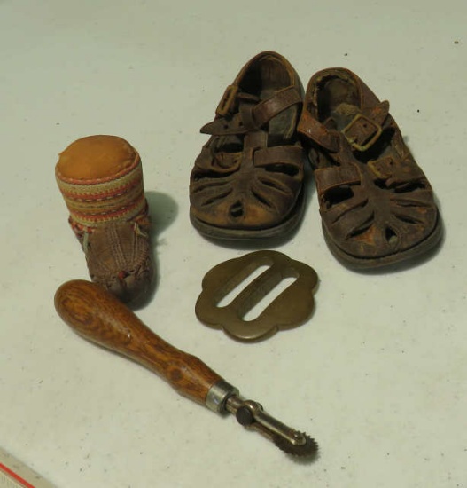 children's pair shoes, pin cushion, brass belt buckle, sewing utensil