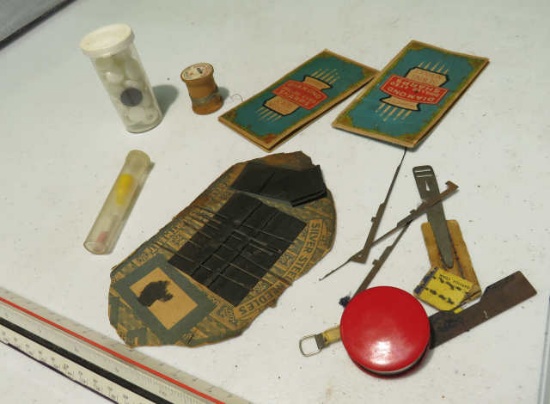 assorted vintage sewing supplies, needles, tape measure, spool