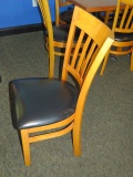 heavy duty wood commercial dining chairs with black vinyl cushions  (located upper level)