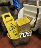 mop bucket and wet floor sign