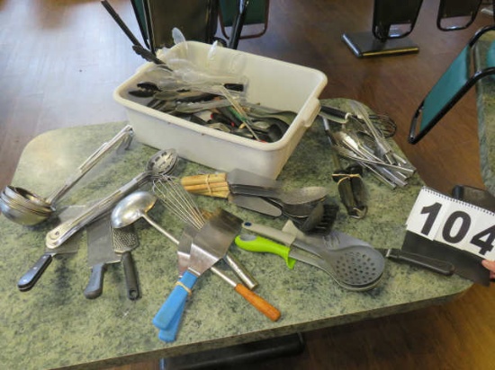 group of utensils including tongs, spatulas, stainless serving spoons, and other commercial service