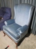 Medium blue upholstered wing back parlor chair