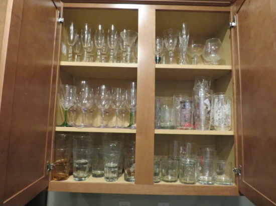 mixed glasses and stemware in kitchen cabinet