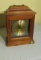 wood framed table clock with key wind (one side glass needs regluing) comes with  mirrored base, 14”