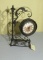 metal framed battery powered analog clock with rotating mirror on rear 20” high x 9” w x 10” deep