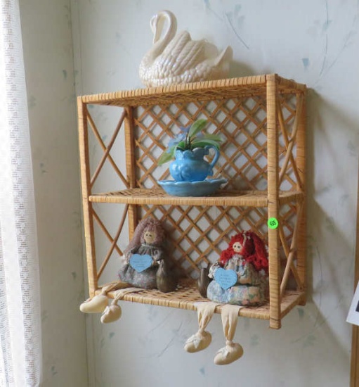 wicker shelf with sitting rag dolls