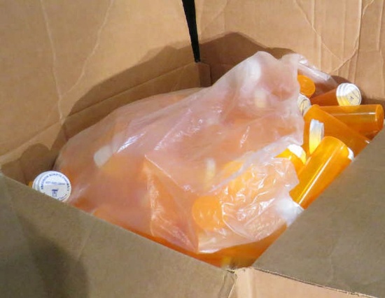 boxes of new pill bottles with lids