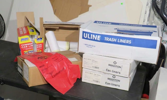 assorted boxes of can liners and box hasmat bags