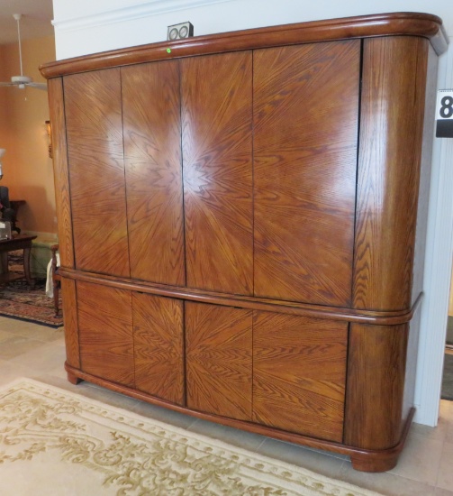 Fine finished Oak starburst grain entertainment cabinet with rounded corners, 79” H x 89” W x 21” D.