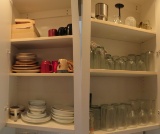 glasses and cups in kitchen cabinets