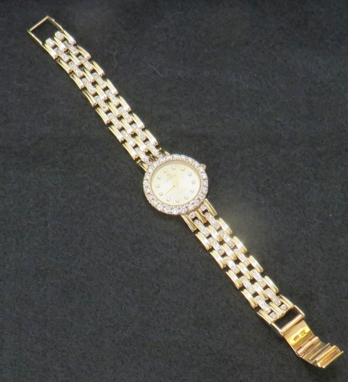 14K Genève Euro Gold watch with diamond bezel and on band.   This watch was examined for authenticit