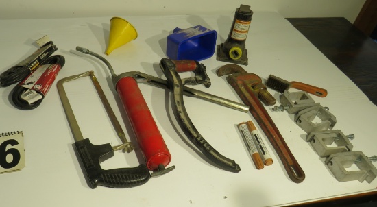 mixed tools including pipe wrench, hack saws, aluminum clamps, lube gun
