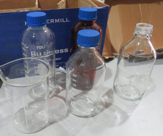 mixed glassware including chemical bottles, beakers, measuring ups