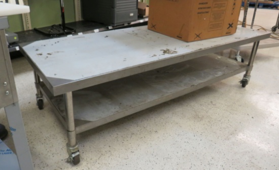 low stainless table with under shelf 72" x 30" x 19" on casters Note: this table was used in the ...